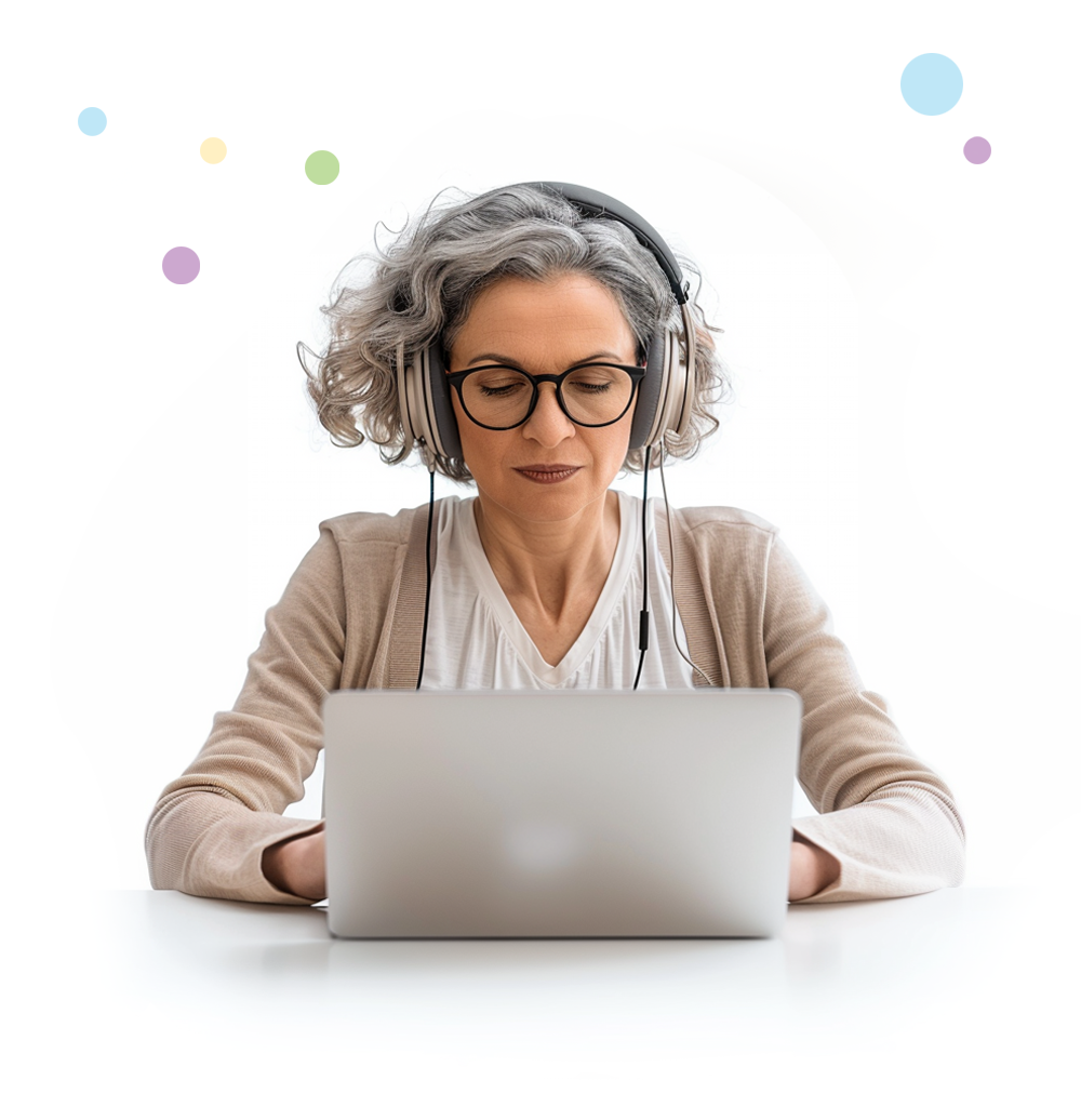 Woman sitting at a desk looking at a laptop